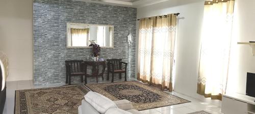 a living room with a couch and a table at Mas Homestay in Teluk Panglima Garang