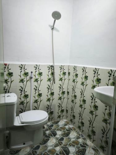 a bathroom with a toilet and a sink at Sama Sama Homestay & Trekking Only Stay Here Book Trekking and Transport With Us in Bukit Lawang