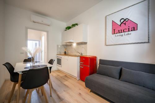 a living room with a couch and a table and a kitchen at Renzo & Lucia Living Lake in Malgrate