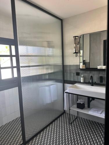 a bathroom with a shower and a sink and a mirror at Ultimate Provence Hotel & Spa in La Garde-Freinet