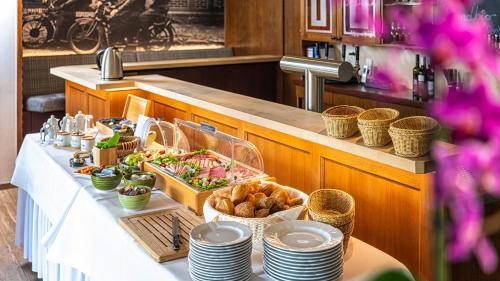a buffet line with food on a table at Hotel Restaurant "Zur Post" in Holdorf