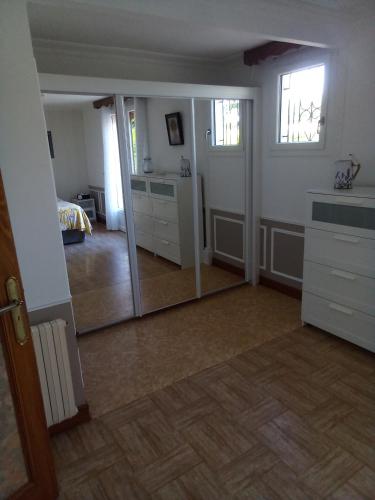 a room with a mirror and a bedroom at La Reposee in Larchamp