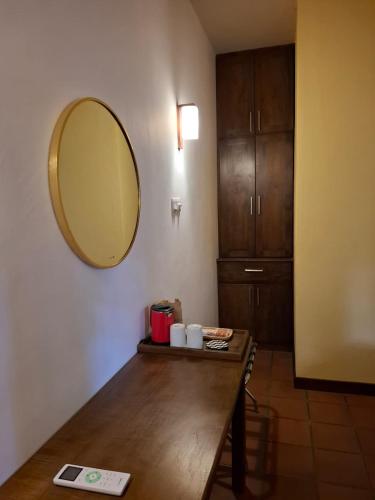 a room with a table and a mirror on the wall at Villa A50 in Negombo