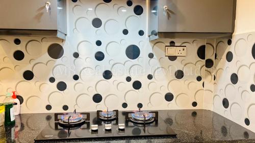 a kitchen with a wall with black and white polka dots at M8 Ocean King Three Bed Apartment in Cinnamon Gardens