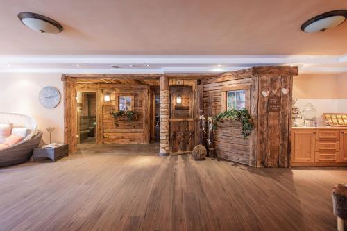 a living room with wooden walls and wooden floors at Stacklerhof in Neustift im Stubaital