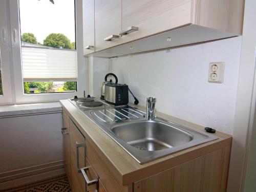 a kitchen with a stainless steel sink and a window at Wohnung in Neubukow nahe Ostseestrand in Neubukow