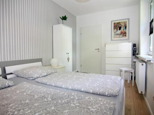 a bedroom with two beds and a kitchen at Wohnung in Neubukow nahe Ostseestrand in Neubukow