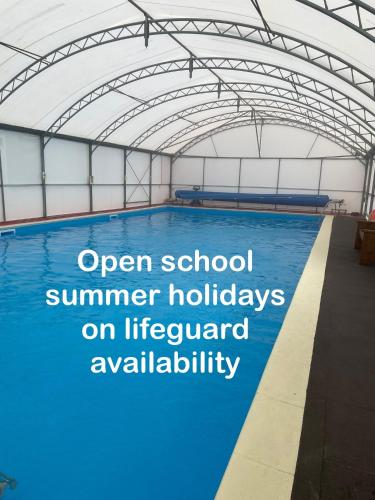 an open school summer holidays on a swimming pool at Caban Croeso-The Welcome Cabin, Holiday let, near Mansion House Llansteffan in Llanstephan