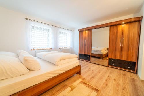 a bedroom with two beds and a large mirror at Promenada Apartamenty i Domek Nad Jeziorem in Mikołajki