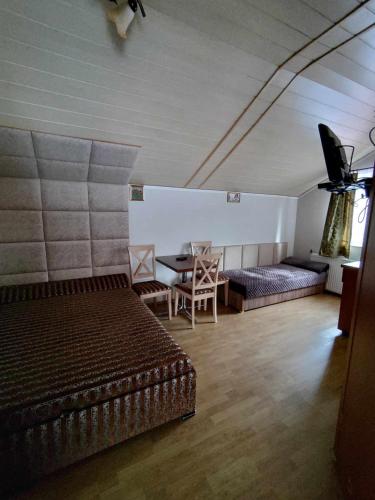 a bedroom with a bed and a table and a couch at Noclegi na Cichej - Łosiówka in Sztutowo