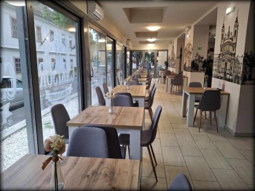 a row of tables and chairs in a restaurant at Hotel Unicornis in Eger