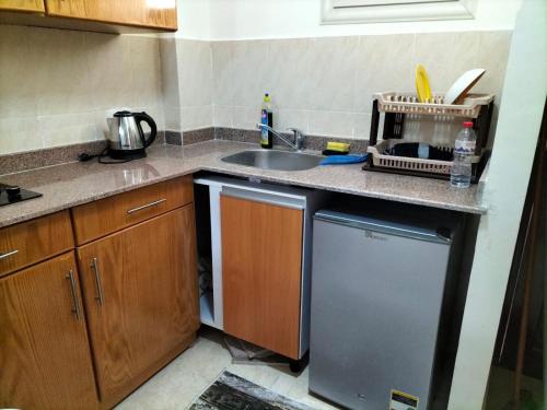 a kitchen with a sink and a dishwasher at Makkadi Orascom Chalet in Sahl Hasheesh