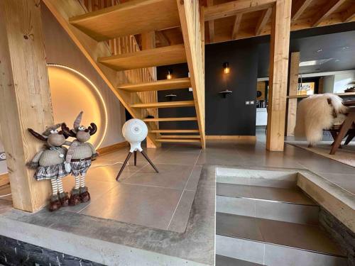 a dog standing in a room with a staircase at Chalet d'architecte avec vue panoramique in Allos