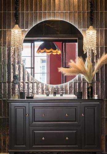 a bathroom with a black dresser and a mirror at Host Inn Bien-être SPA JACUZZI Downtown in Lyon
