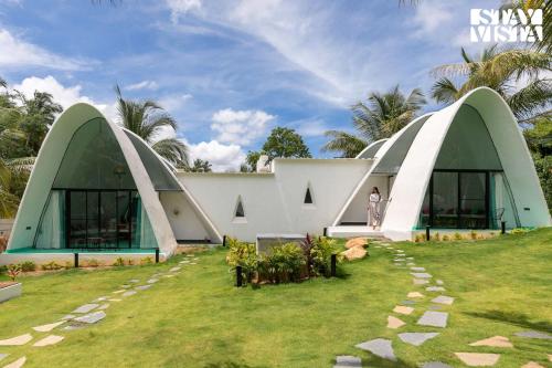 a building with two domes on the side of it at StayVista at Shwaas 4BR Mysore with Private pool and landscape in Mysore
