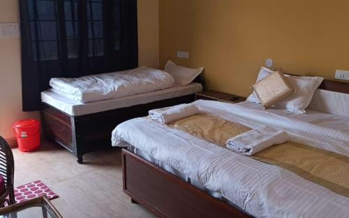 a room with two beds in a room at Om Retreats by StayApart in Gupta Kāshi