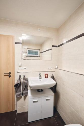a bathroom with a sink and a toilet at Fewo Huber in Bad Waldsee