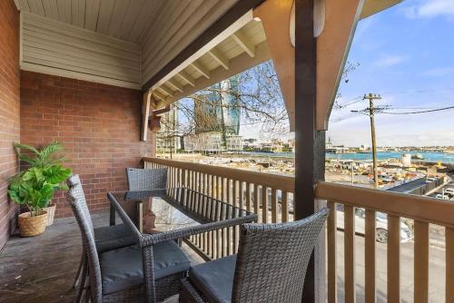 a porch with wicker chairs and a view of the water at Vacation Home w Private Rooftop and Harbour View in Sydney