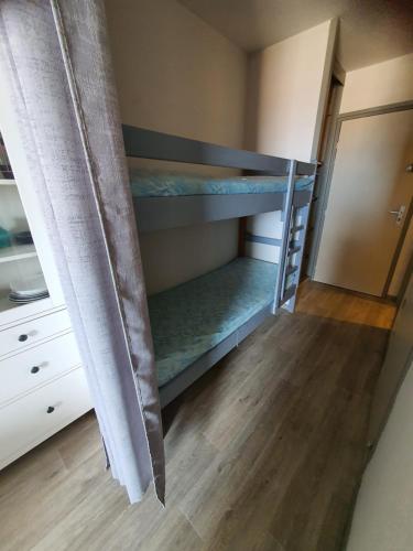 une chambre avec deux lits superposés et un placard dans l'établissement Le PHOEBUS, à Canet