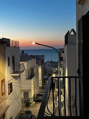 a view of a city from a balcony with a street light at Peschici Central Room - vista mare in Peschici