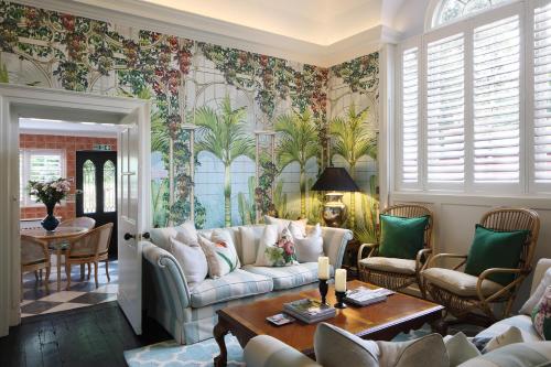 a living room with a couch and a table at Palm House - Luxury Wye Valley Country House 2 Bed Apartment - Dog Friendly in Newland