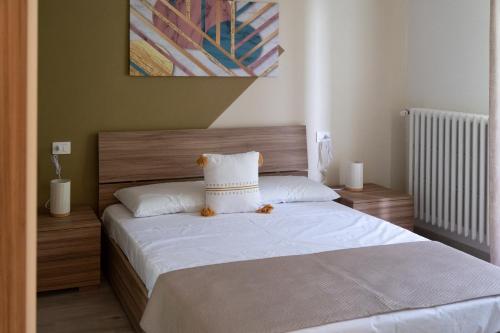 a bed with a teddy bear sitting on top of it at Casa vacanze Aria in Leggiuno