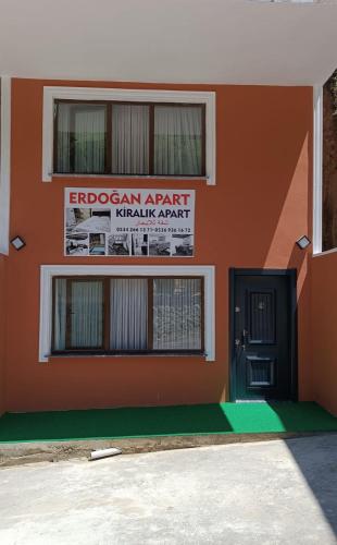 a building with a sign on the side of it at Erdoğan Konut in Çaykara