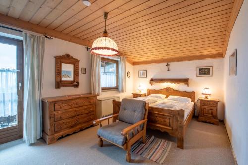 a bedroom with a bed and a desk and a chair at Haus Steinbock Top 1 in Krimml