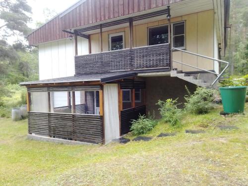 a house with a balcony on the side of it at Apartment by the park in Imatra
