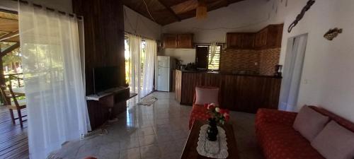a living room with a couch and a table at Maison Angèle in Nosy Be