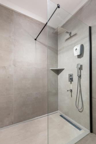 a shower with a glass door in a bathroom at Cumbalıca Garden Hotel in Cesme