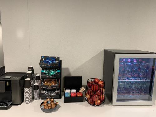 a counter top with a display of food and a refrigerator at Centurion Swiss Quality Towerhotel Windisch in Brugg