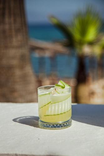 a drink in a glass sitting on a table at Akti Hotel Kavala in Paleo Tsifliki