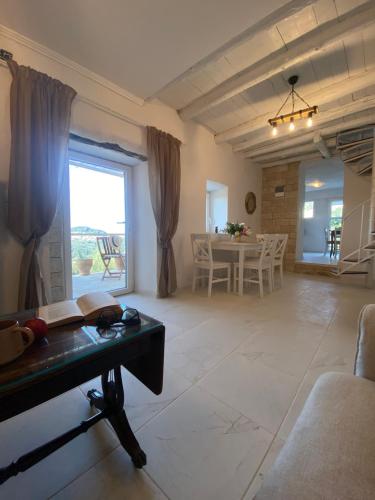 a living room with a table and a dining room at Dinateli Houses - Live like a local in Corfu in Kastellánoi