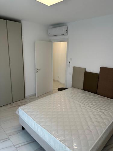 a bedroom with a large bed in a room at Beach Palace with small swimming pool, private beach, parking in Lido di Jesolo