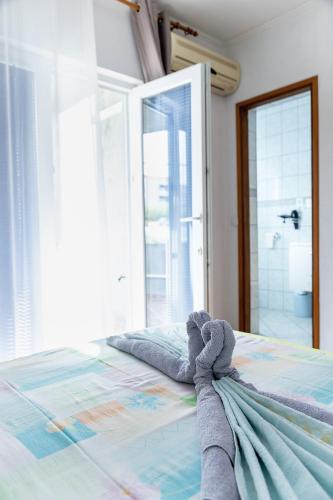 a teddy bear laying on a bed in a bedroom at Apartment Anamaria in Pag