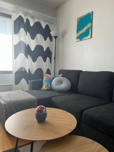 a living room with a couch and a table at Vääksy rivitalo 62 m2 in Asikkala