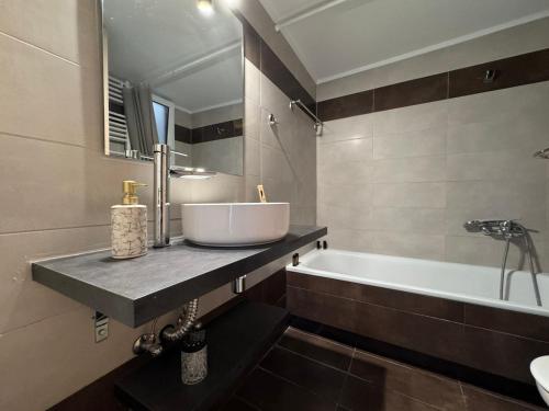 a bathroom with a sink and a bath tub at Xasteria apartment Ξαστεριά in Poros