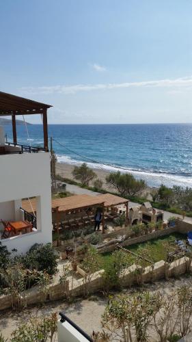a view of the ocean from the balcony of a building at Finikas Studios & Apartments - Kalamaki Holidays in Kalamaki