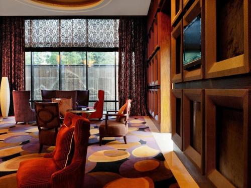 a living room with a fireplace and chairs and a table at Putian Depo Hotel in Putian