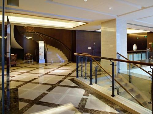 a lobby with a staircase in a building at Putian Depo Hotel in Putian