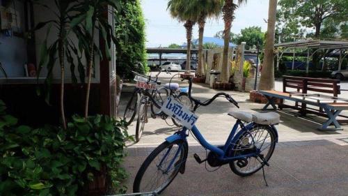 a bike with a police sign on it parked on a sidewalk at Hihotel Saraburi in Sara Buri