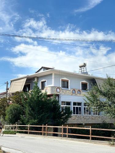 a white building on the side of a street at Guest House Adi Hoxha in Berat