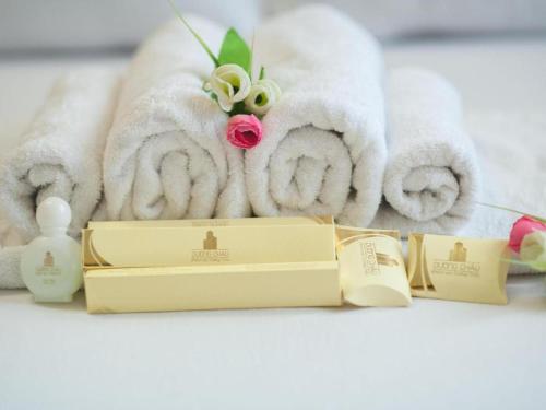 a pile of towels and a box of soap at Duong Chau Hotel in Bùi Tiếng