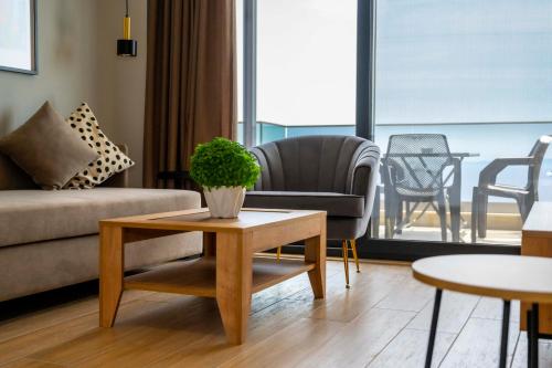 a living room with a couch and a table at RiA BLU DELUXE HOTEL in Neos Marmaras