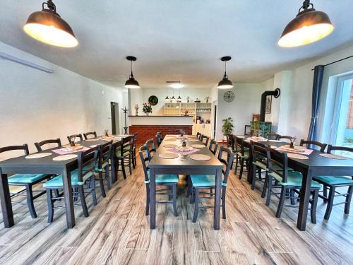a dining room with tables and chairs in a restaurant at Penzion Kozí zámek in Horažďovice