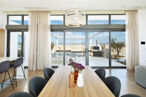 a dining room with a wooden table and chairs at Minthis Resort in Paphos City
