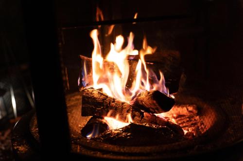 a fire is burning in a fire pit at 小別沢プライベートグランピングQuope in Sapporo