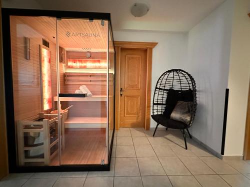 a glass door leading into a room with a chair at Haus Anna in Sankt Anton am Arlberg