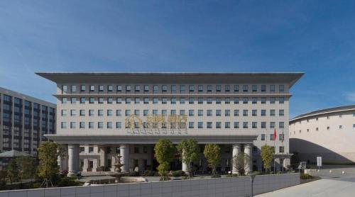 a large white building with a lot of windows at Cozy Hotel Xiamen in Xiamen